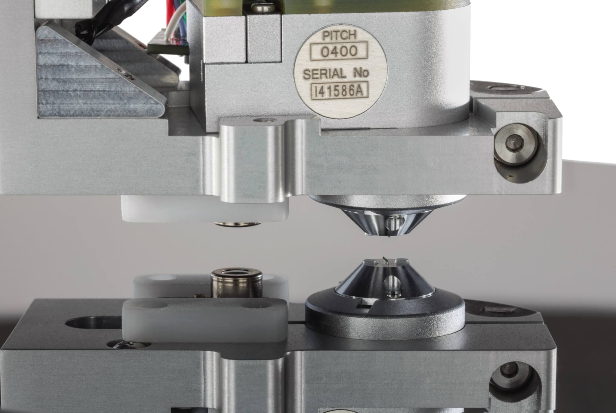 Four-point probe tip above wafer sample